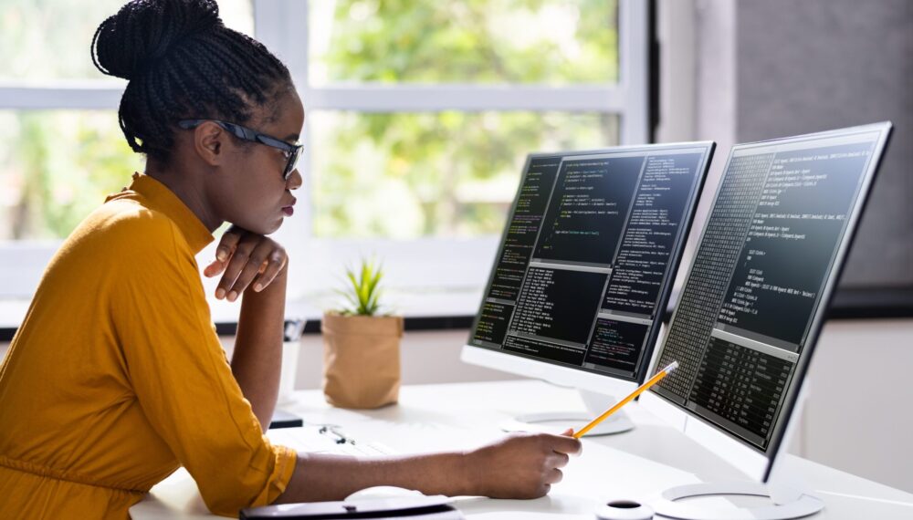 Female-Software-developer-writing-on-code-on-computer